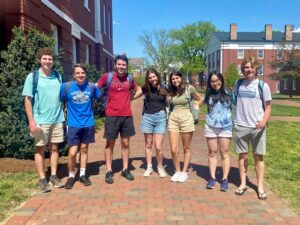 Seven young adults standing in a line on the campus of Washington and Lee University