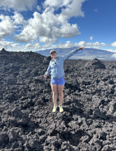 standing on the 2022 lava flow with Mauna Kea in the background